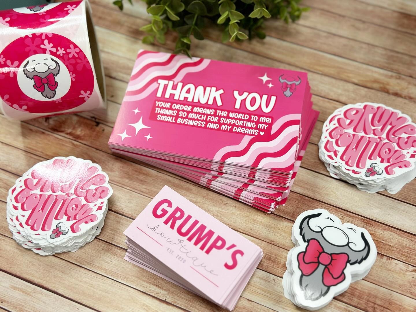 A custom business logo sticker held in front of matching printed stickers.